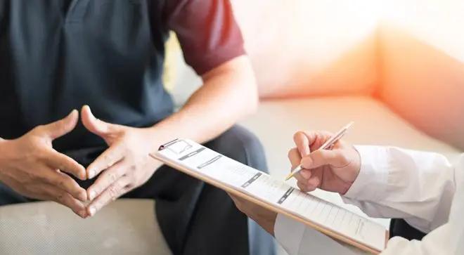 An image of a doctor and patient talking with one another.