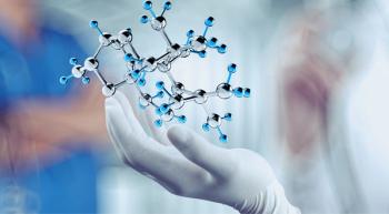 genetics held up by gloved clinician hand