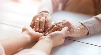 caregiver holding hands with patient
