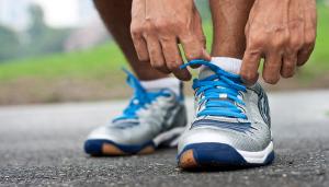 man tying running shoes