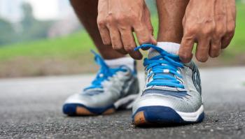 man tying running shoes
