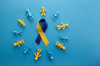 World Down syndrome day on blue background. Down syndrome awareness concept. Top view | Image credit: © vetre - © stock.adobe.com