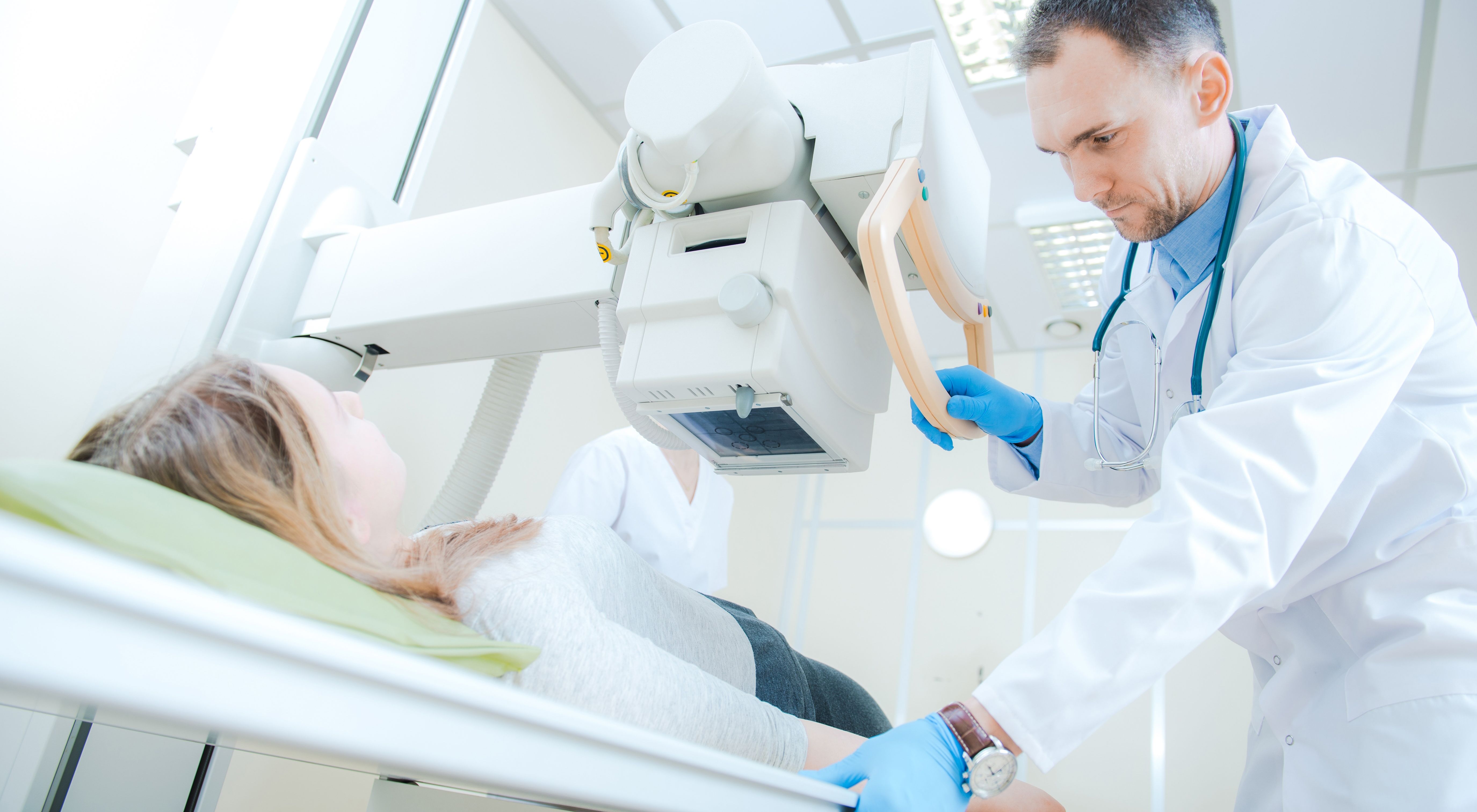 doctor giving radiation treatment to a woman