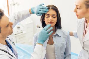 doctors examining a patient's face