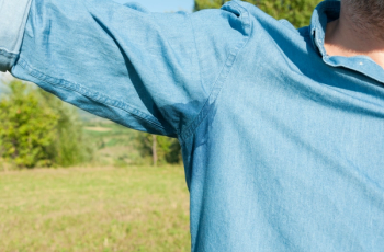 Underarm sweat on blue shirt