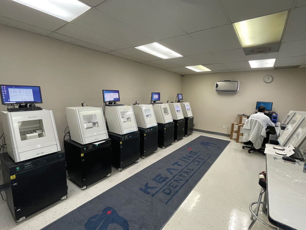 A lab technician at work among the DGSHAPE DWX mills at Keating Dental Lab.