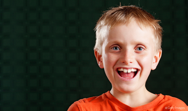Blond 8 year old boy makes funny bugs bunny face - buck teeth stock picture...