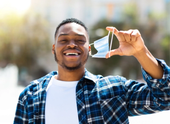 man taking off mask