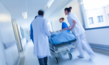 healthcare team rushing patient on a bed