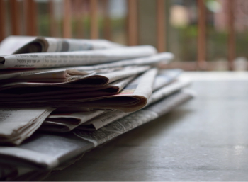 pile of newspapers on a table