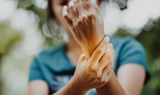 Rheumatoid Arthritis patient holding wrist