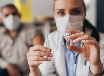 pharmacist administers vaccine