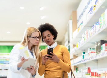 pharmacist and patient look at phone