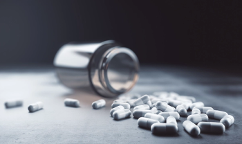 pills spilled over dark background
