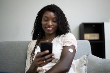 woman using CGM device | Image Credit: Andrey Popov - stock.adobe.com