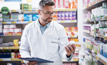 pharmacist holding pill bottle