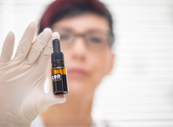 pharmacist holding CBD product