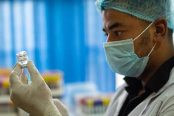 pharmacist administers COVID vaccine