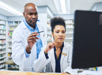 two pharmacists reading news online