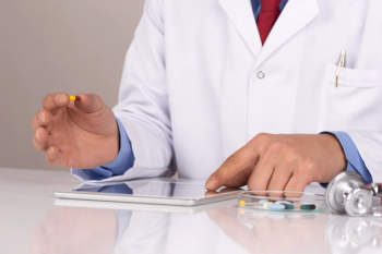 pharmacist with pills and ipad