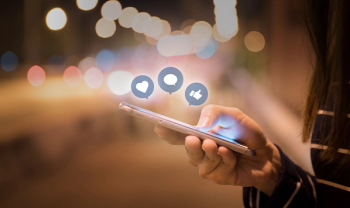 cellphone with heart quote and like icons