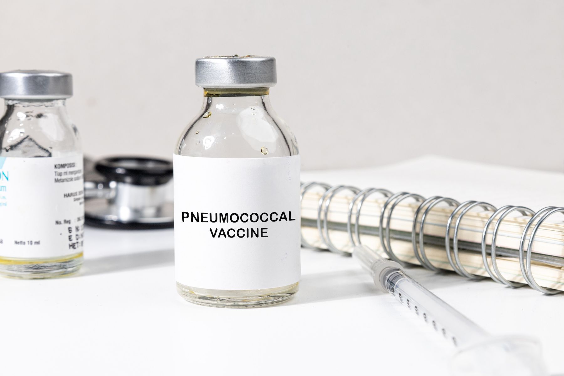 Pneumococcal vaccine bottle on a desk | Image credit: Kamitana - stock.adobe.com