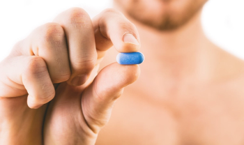 man holding blue pill