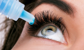 woman applying eye drops