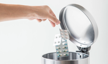 throwing pills in trash can