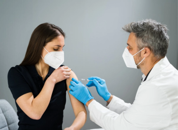 pharmacist administering COVID-19 vaccine