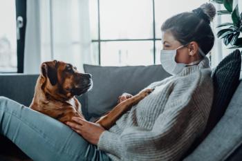 hugging dog with mask on