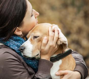 woman hugging dog