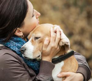 woman hugging dog