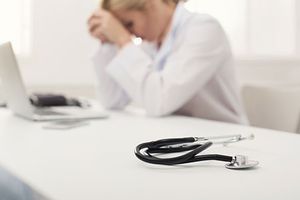 veterinary-tired-sad-female-doctor-desk-stethoscope-AdobeStock_198075823-450.jpg