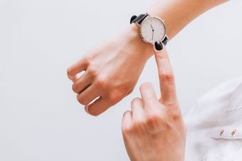 veterinary-young-business-woman-is-late-on-time-in-a-hurry-she-checks-the-deadline-on-her-classic-watch-shutterstock-407554348-450.jpg