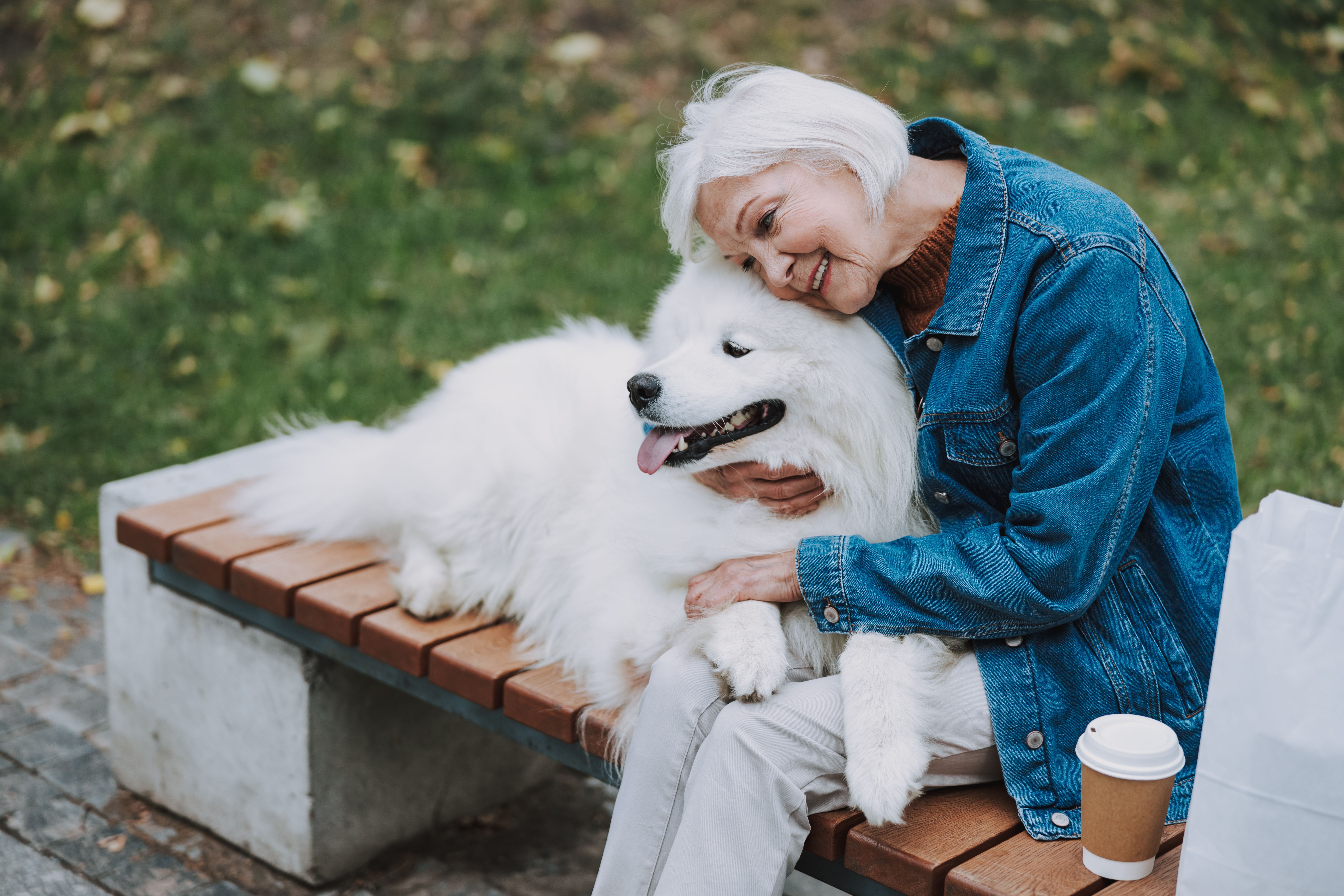 older woman hugging dog
