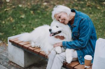 older woman hugging dog