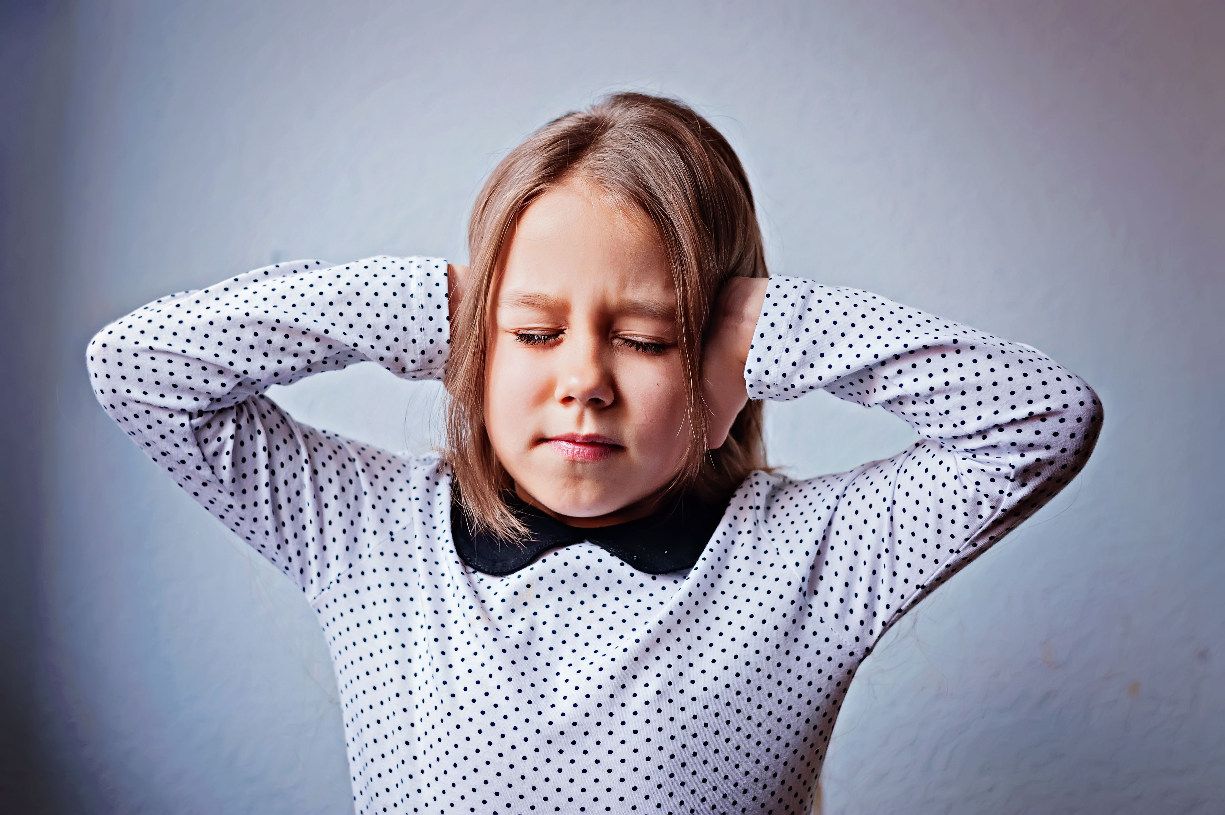 girl covering her ears