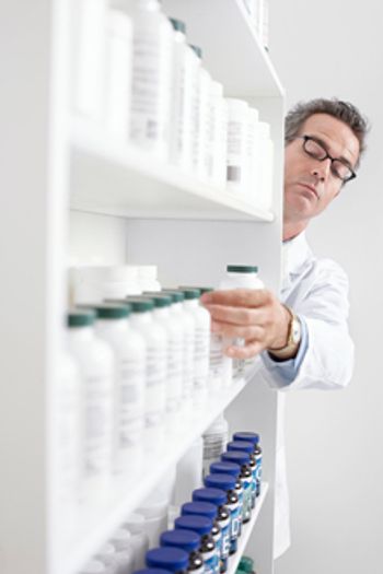 veterinary-Pharmacist-Taking-Pills-From-Shelf-220px-90139445.jpg