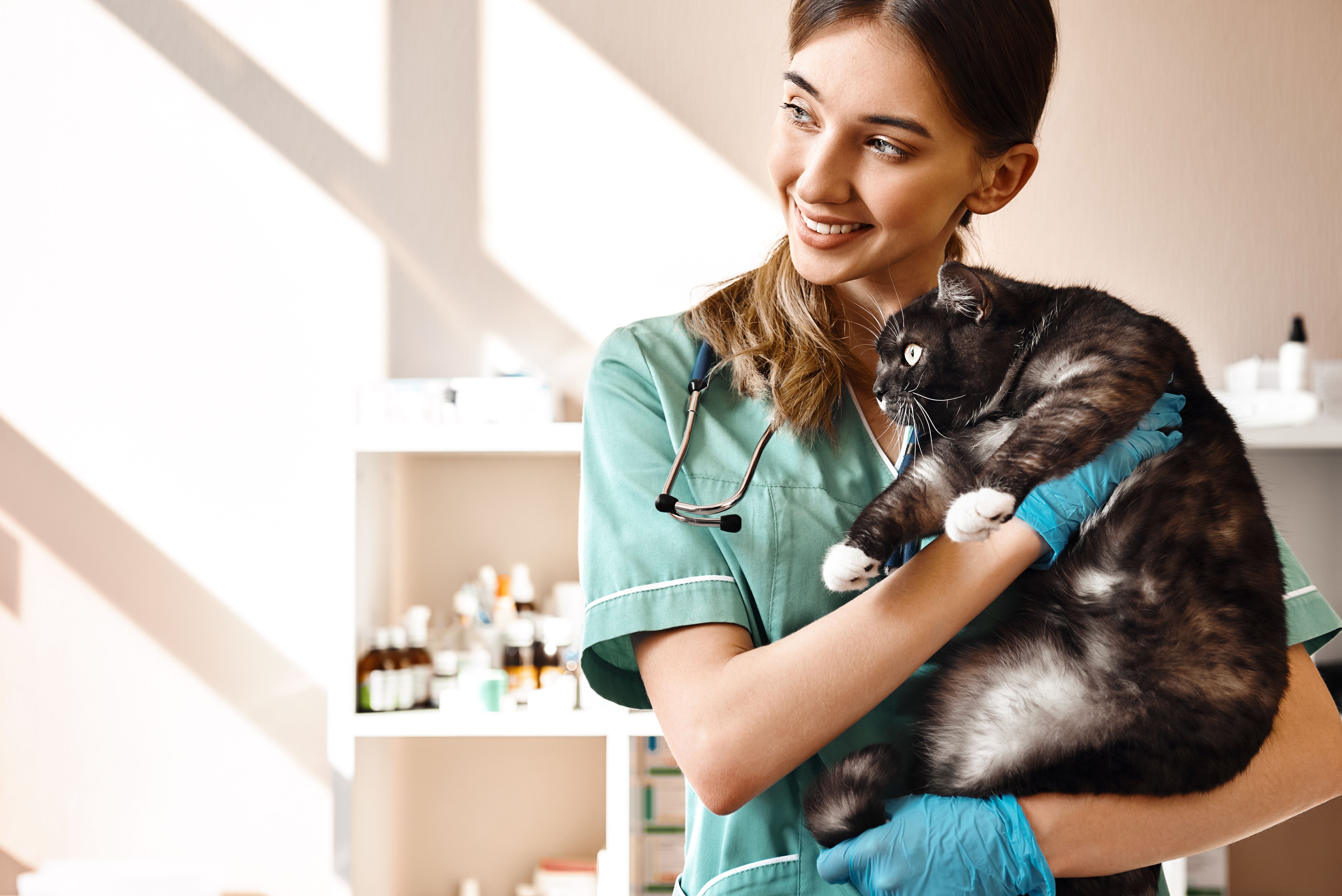 women vet with cat happy