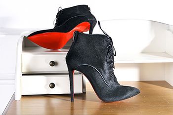 veterinary-Womens-Ankle-boots-handmade-Imitation-brand-shoes-Christian-Louboutin-showing-red-soles-shutterstock_532606762-body.jpg