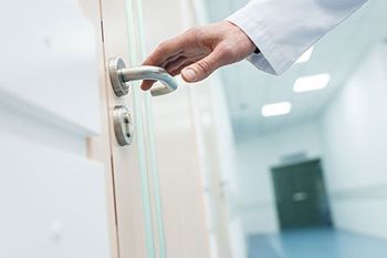 veterinary-hospital-design-hd-door-knob-doctor-hand-AdobeStock_186533551-450.jpeg