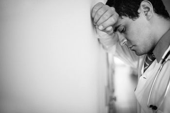 veterinary-sad-doctor-leaning-on-the-wall-450px-shutterstock-486036274.jpg