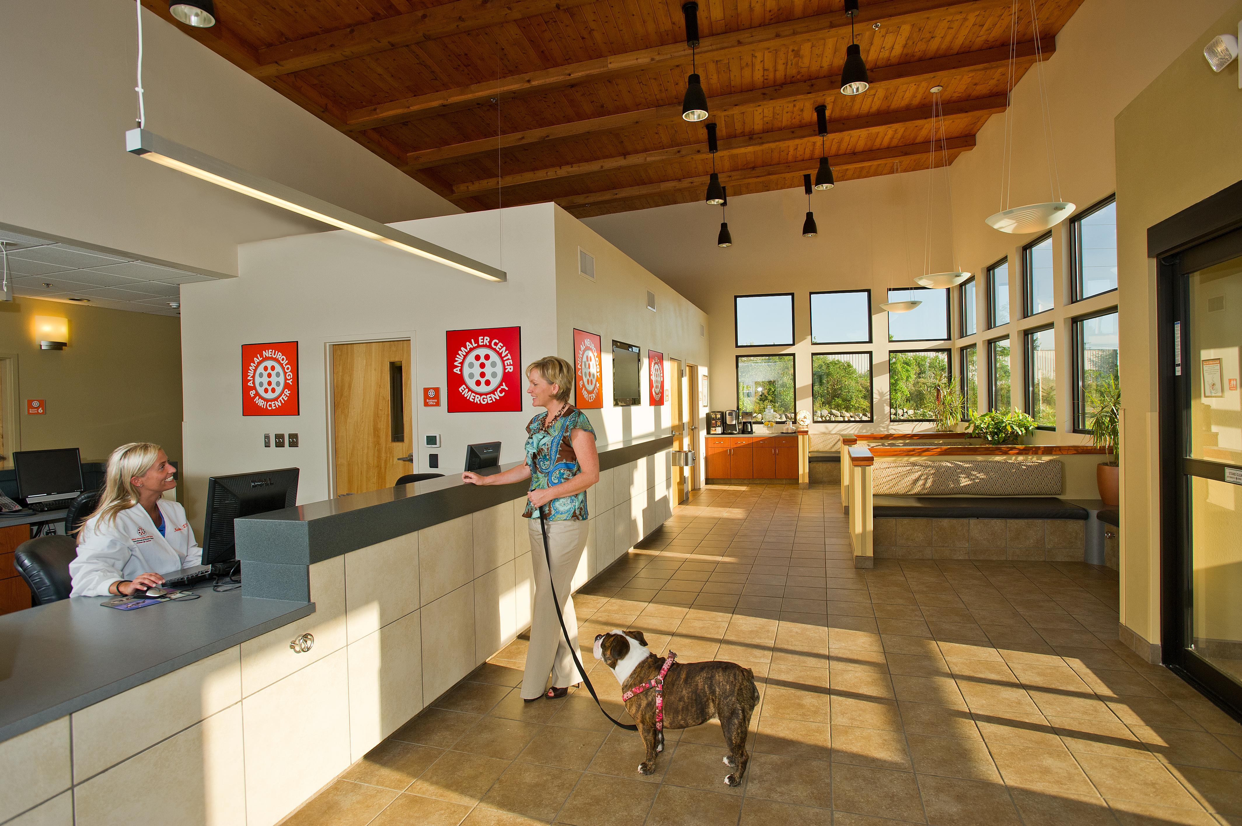 woman with dog at  animal hospital front desk 