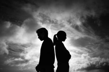 man and woman standing back to back