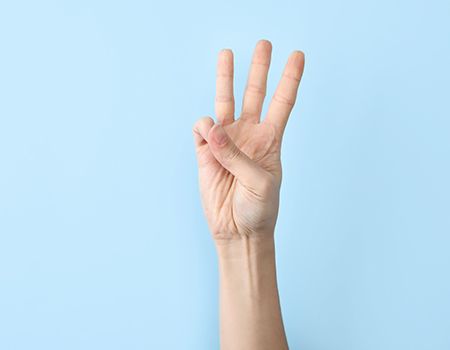 holding up three fingers