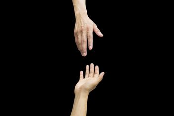 veterinary-helping-hand-and-hands-praying-on-black-background-helping-hand-concept-450px-shutterstock-292045949.jpg