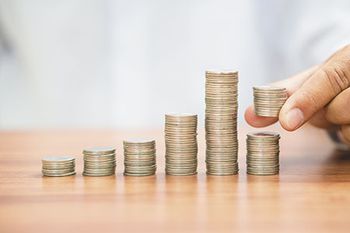 veterinary-hand-add-coin-to-last-stack-or-separate-money-450px-shutterstock-645015949.jpg