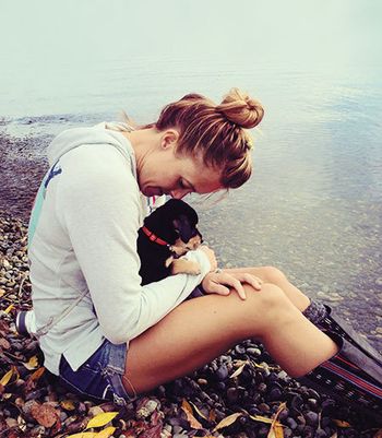 Dog with millennial by lake