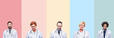 Veterinarians standing against colored backdrop